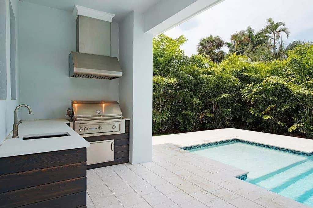 Covered lanai with a summer kitchen and an attached swimming pool.