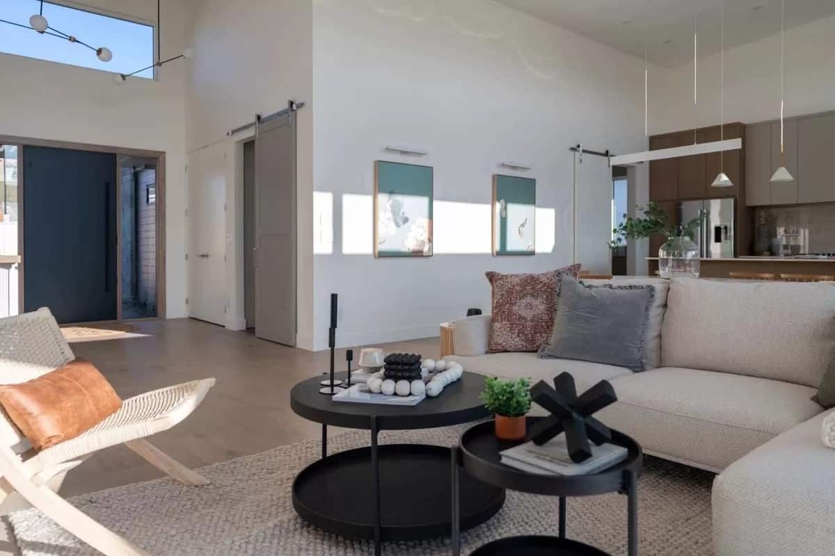 Living room with an L-shaped sectional and nesting coffee tables over the jute area rug.