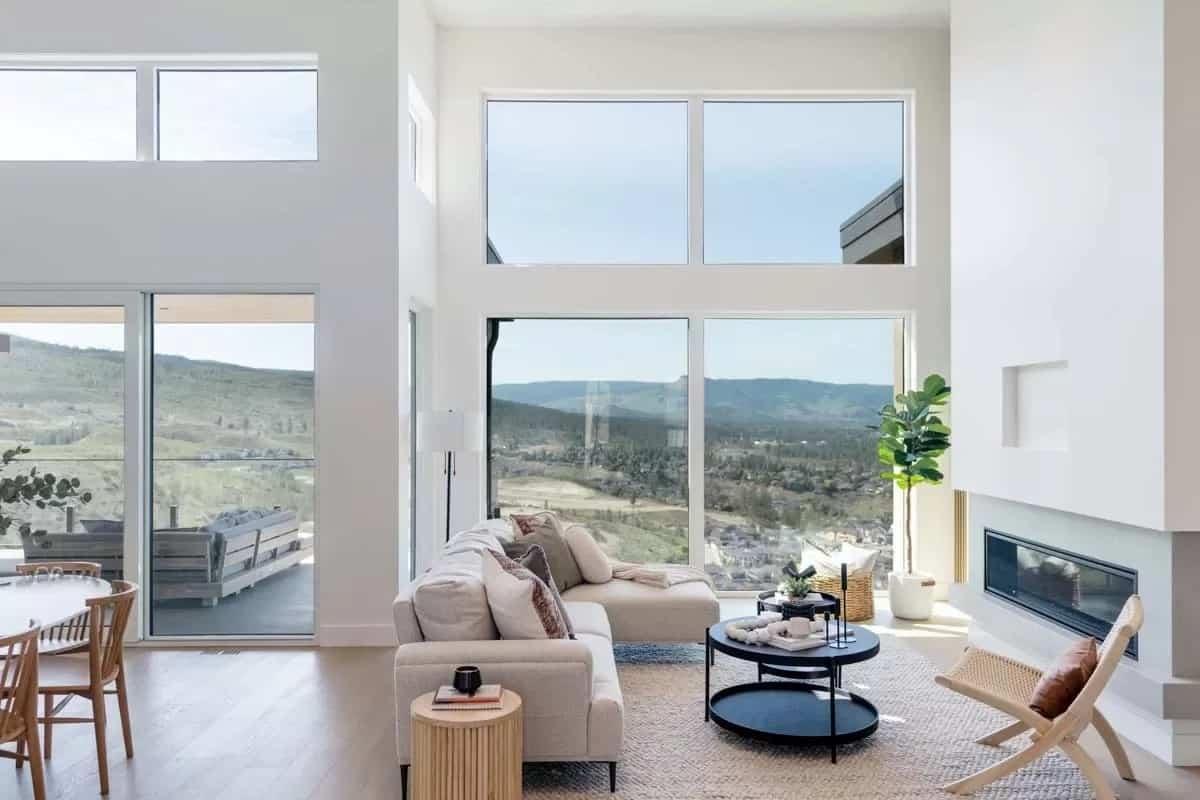 Massive windows flood the living space with abundant sunlight.