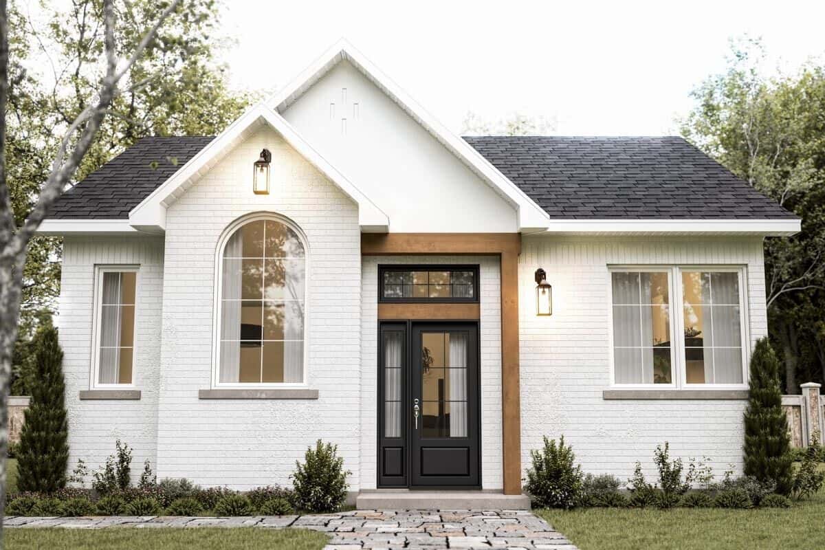 Front view of the house with an arched window and a glazed entry door.