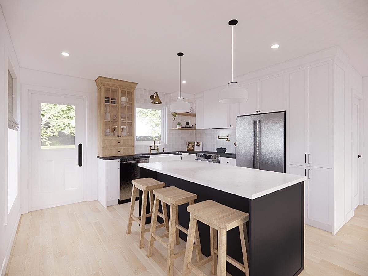 Kitchen with white cabinetry, slate appliances, and a breakfast island with seating for three.