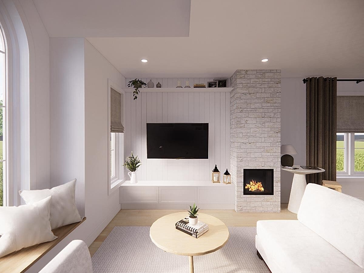 Living room with a white sofa, a stone fireplace, and a wall-mounted TV.