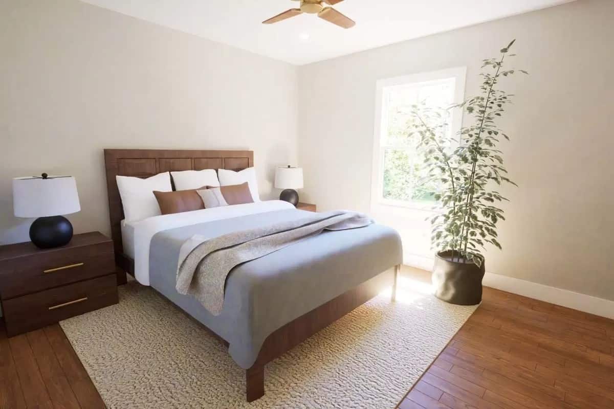 Secondary bedroom with wooden furnishings over the beige area rug.
