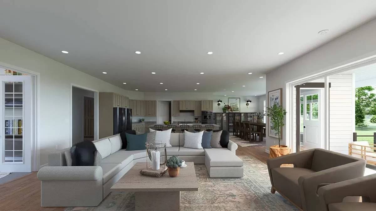 Great room with a sectional sofa, modern chairs, and a light wood coffee table over the vintage area rug.