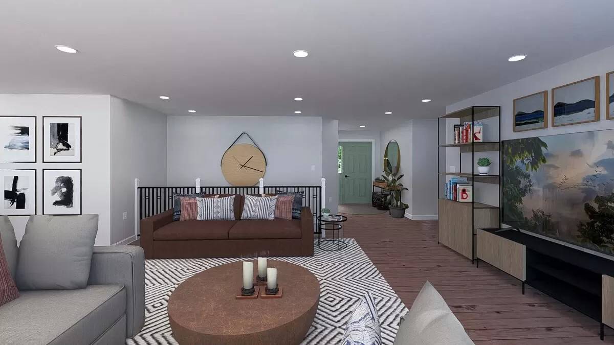 The family room includes a round coffee table sitting on a patterned area rug.