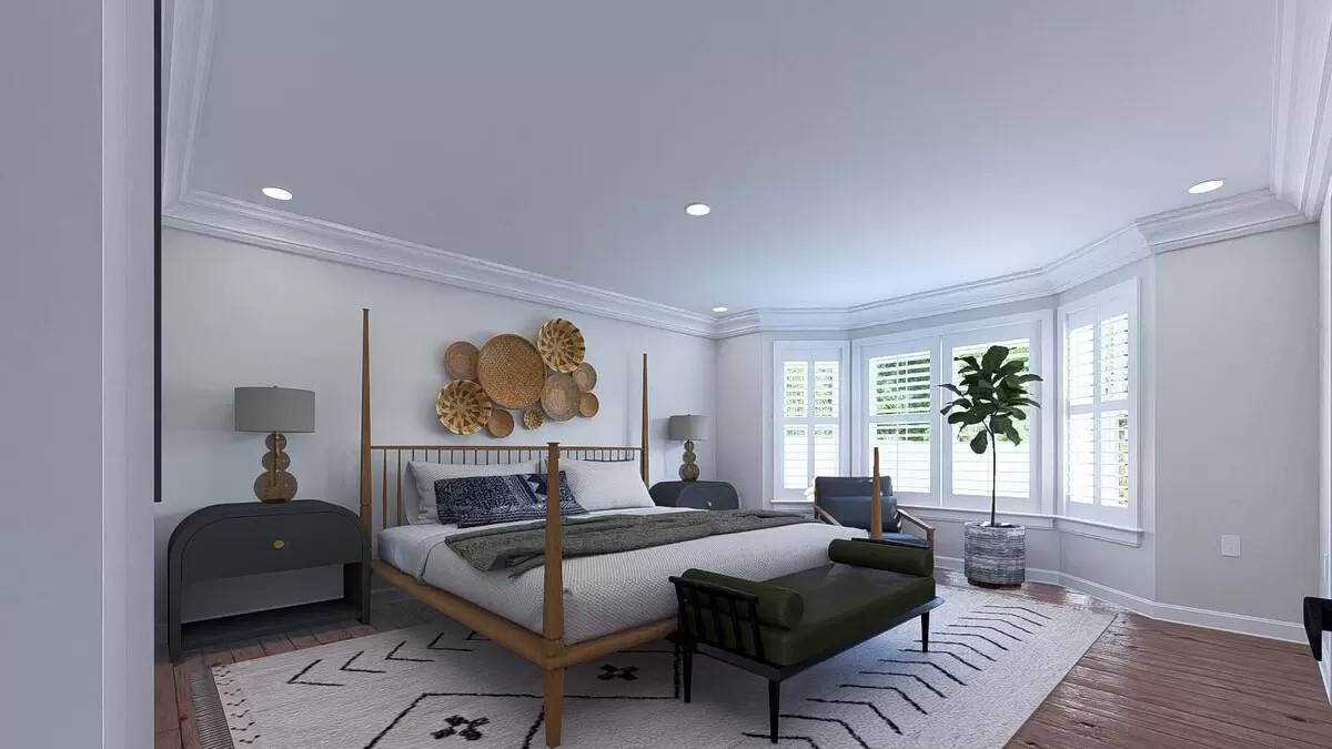Primary bedroom with a bay window and a four-poster bed complemented with a cushioned bench.