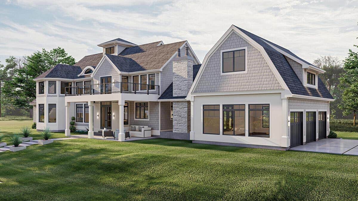 Rear-left view with varied rooflines, a stone chimney, and a covered porch topped with a sun deck.