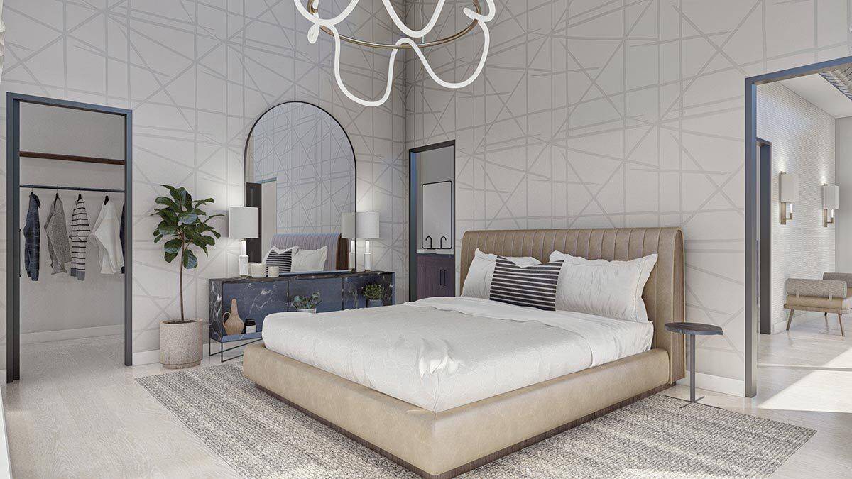 Primary bedroom with an upholstered bed, an ensuite bath, and a walk-in closet.