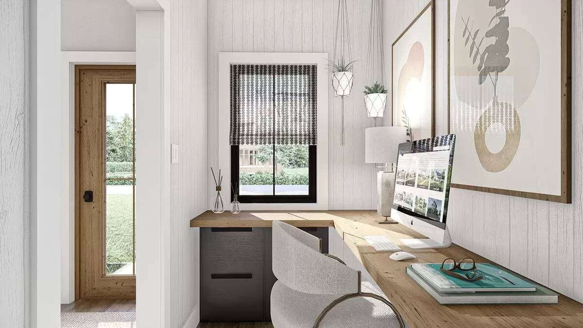 Office with a built-in desk and a framed window.