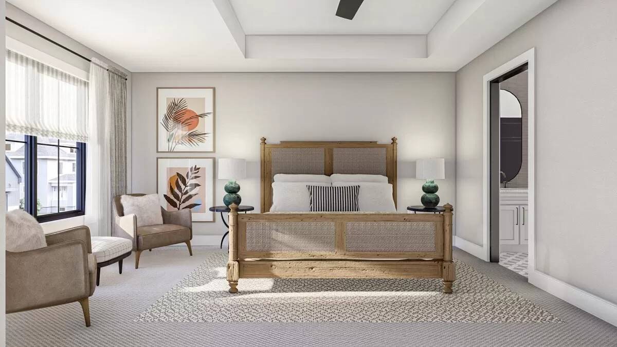 Primary bedroom with a sitting area and a rattan bed under the tray ceiling.