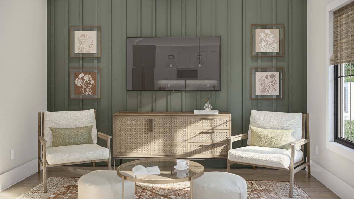 Great room with cushioned armchairs and a TV mounted above the rattan console table.