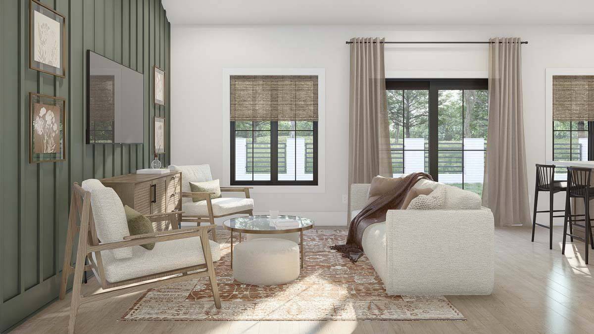 The great room includes a gray sofa and a glass-top coffee table over the vintage area rug.