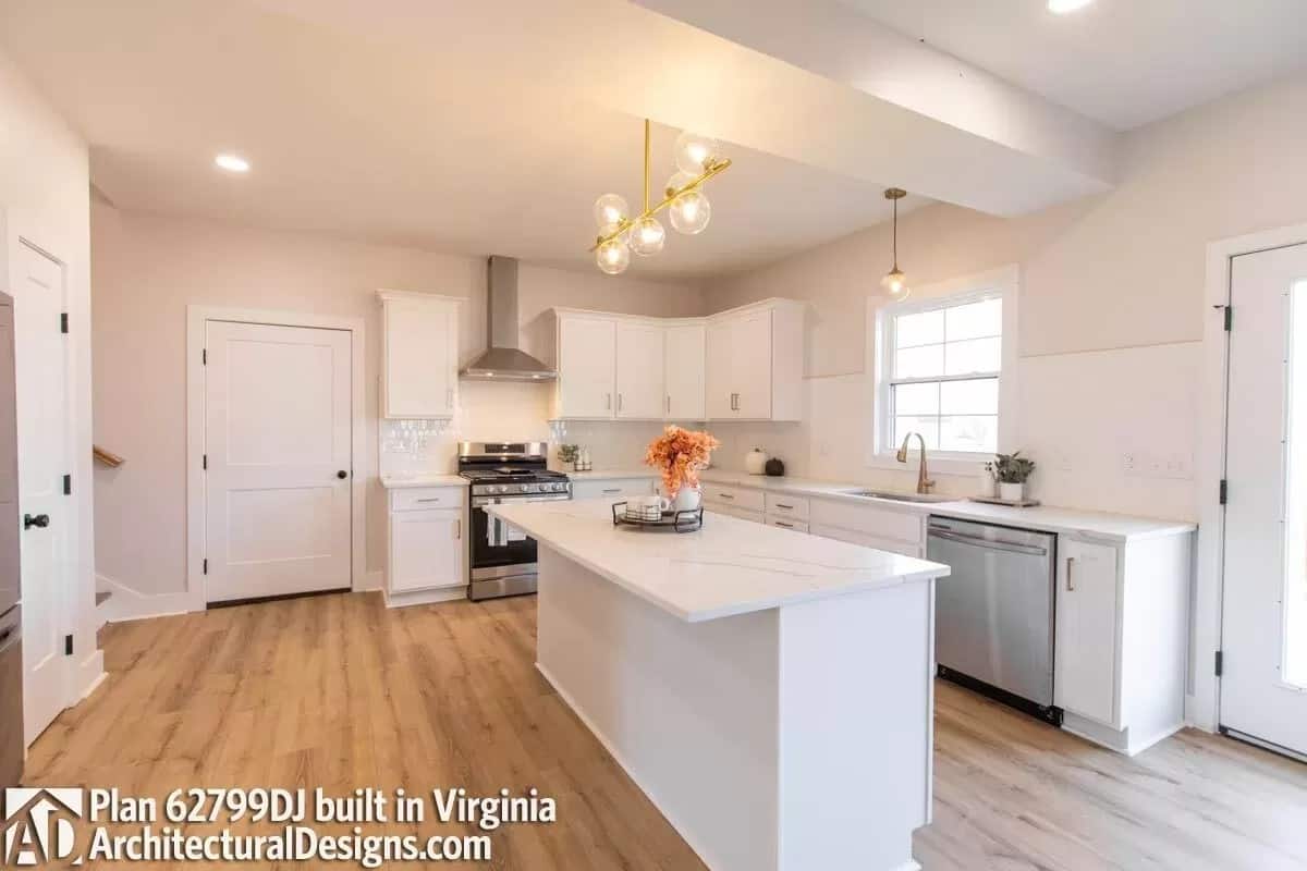 Kitchen with white cabinets, stainless steel appliances, and a center island with bar seating.
