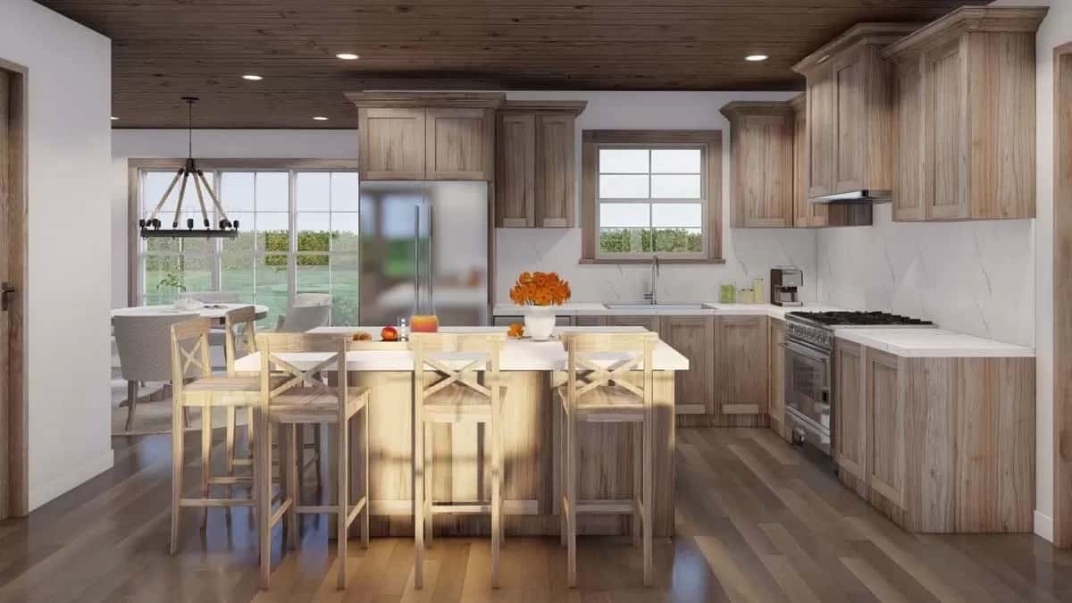 Kitchen with wooden cabinets and a matching breakfast island that blends in with the hardwood floor.