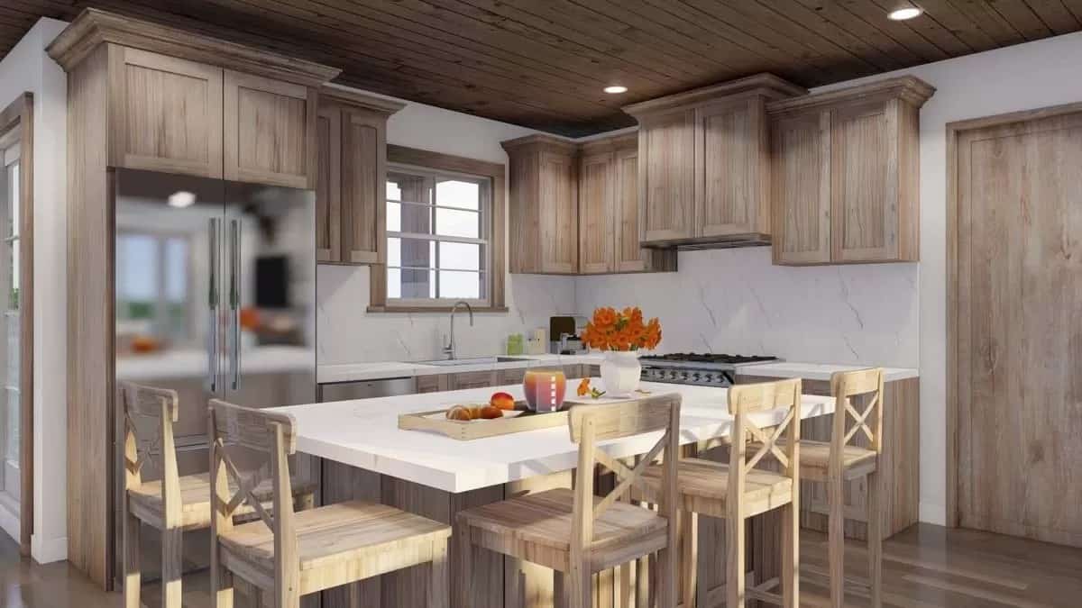 The kitchen includes stainless steel appliances and a sink under the wooden-framed window.