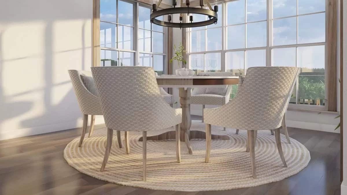 Dining room with a round dining table and round-back chairs over the jute area rug.