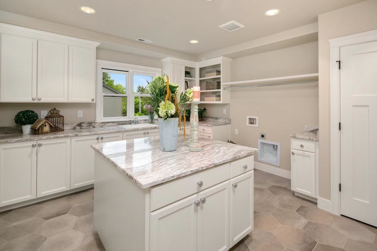 Laundry room with ample storage and a center island.