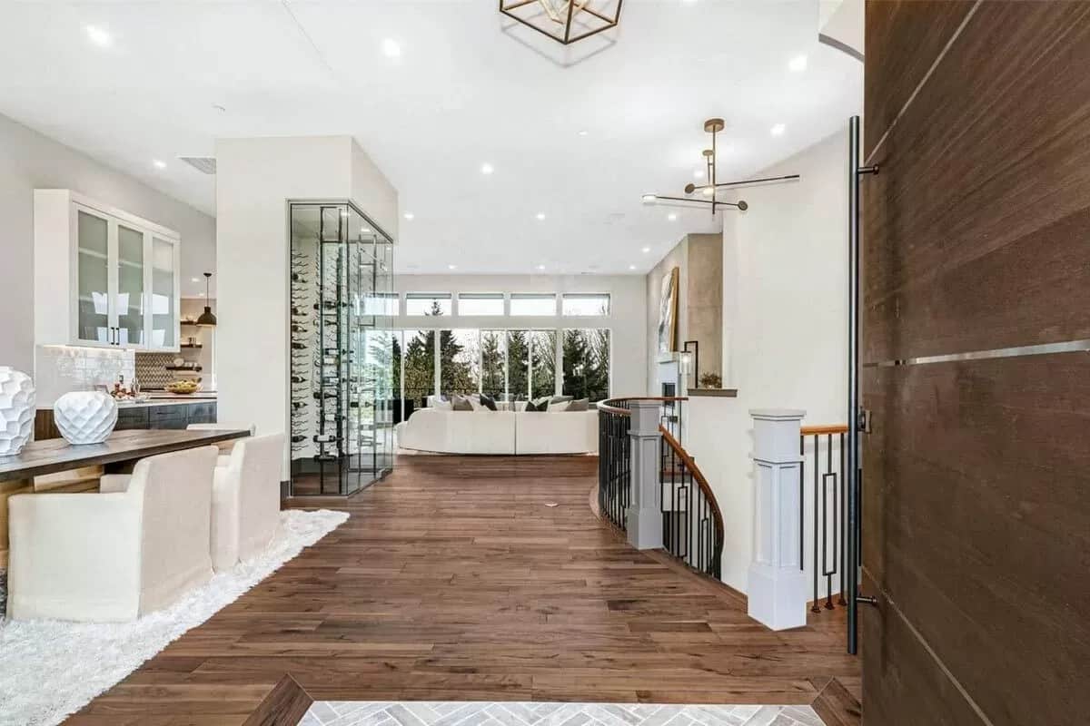 Foyer with a wine display and a staircase leading down to the lower levels.