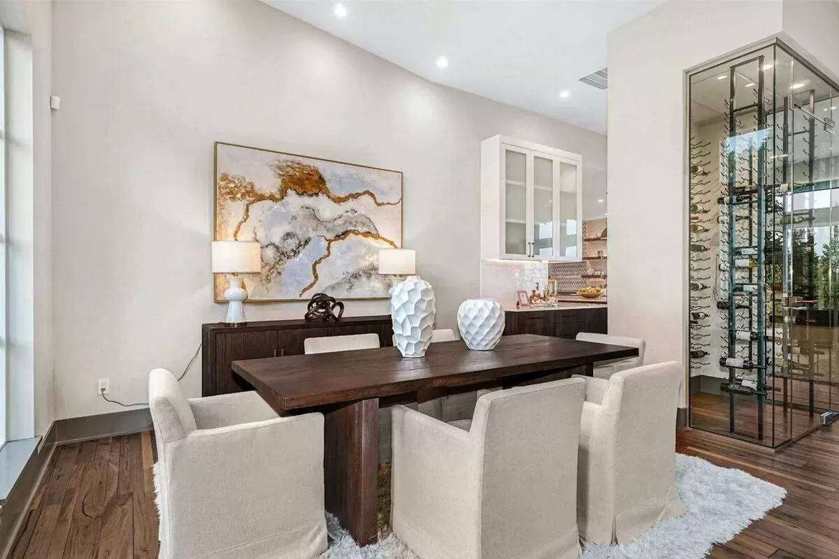 Dining room with a rectangular dining set and a matching buffet table adorned with a large painting.