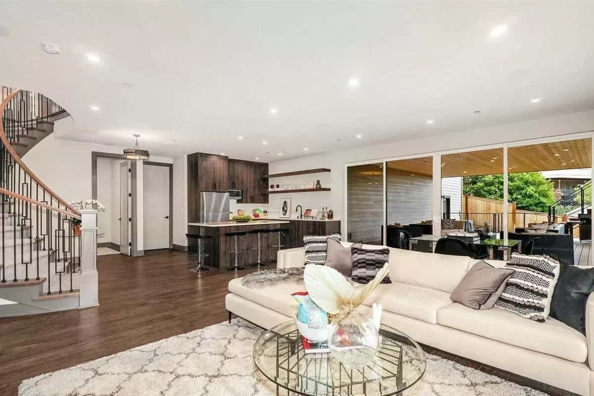 Rec room with a wet bar and an L-shaped sectional paired with a glass-top coffee table.