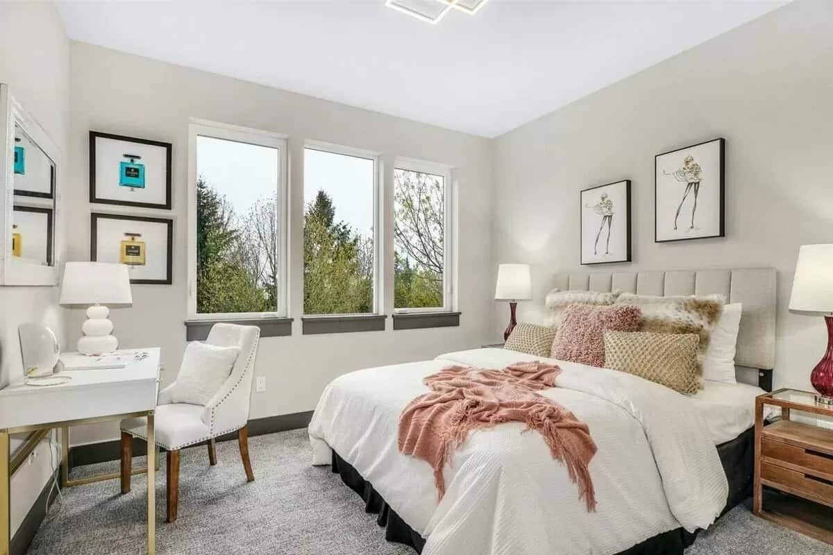 Secondary bedroom with a modern desk and a trio of windows.