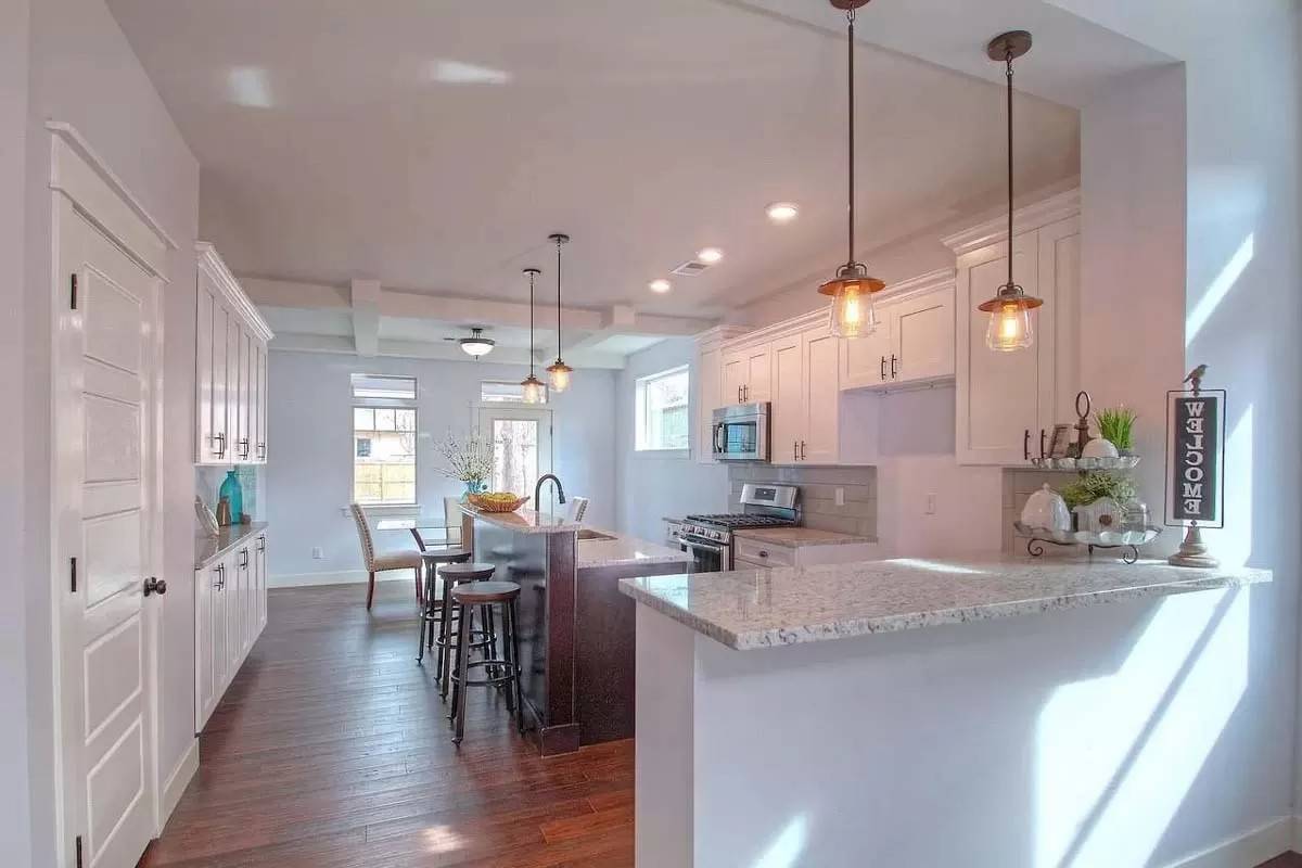 Kitchen with a breakfast island and a peninsula bar.