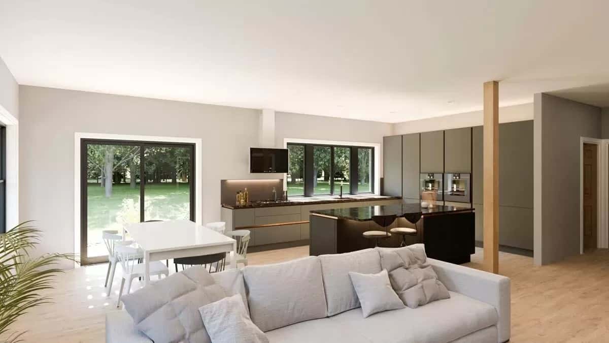 An open layout view of the living room, dining area, and kitchen under the regular white ceiling.