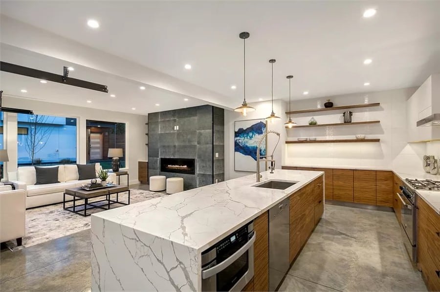 Kitchen and great room connected by an oversized opening.