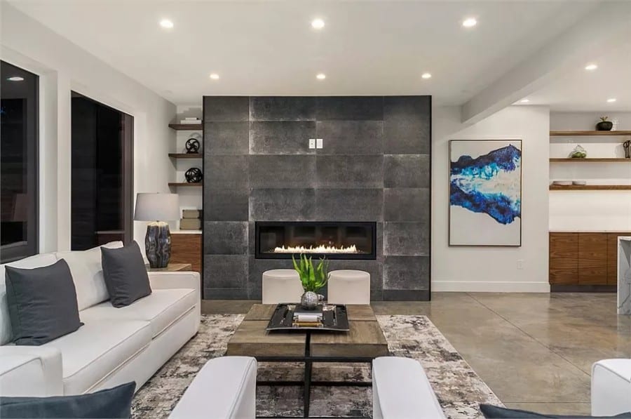 Great room with leather sofas and a large fireplace.