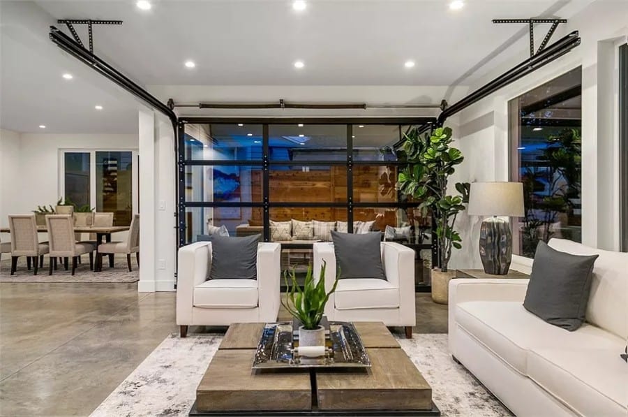 The great room includes floor-to-ceiling windows overlooking the covered patio.
