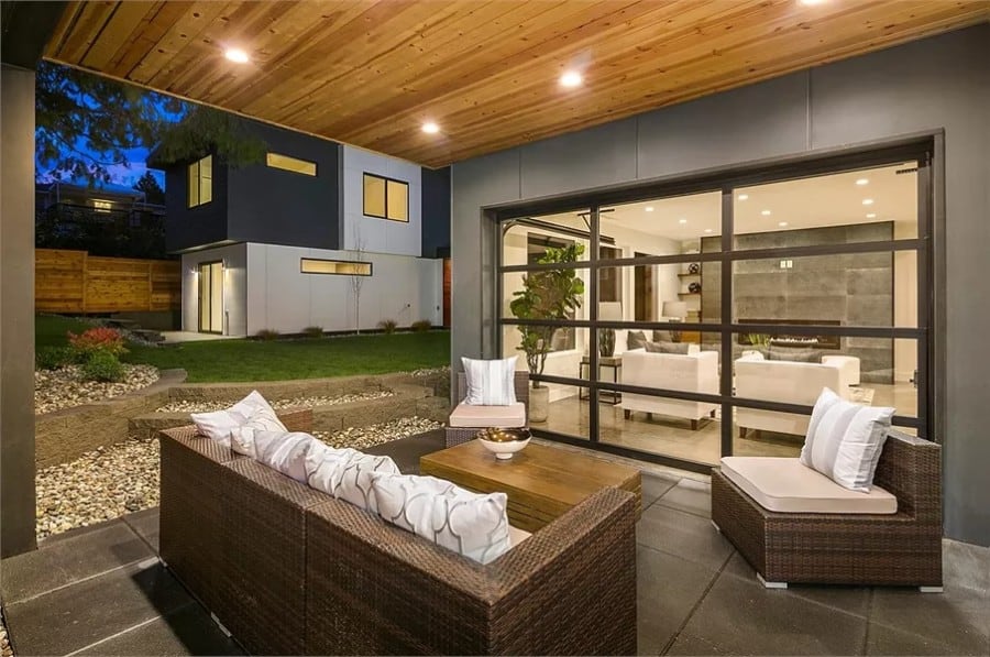 Rear patio with wicker seats and a wooden coffee table.