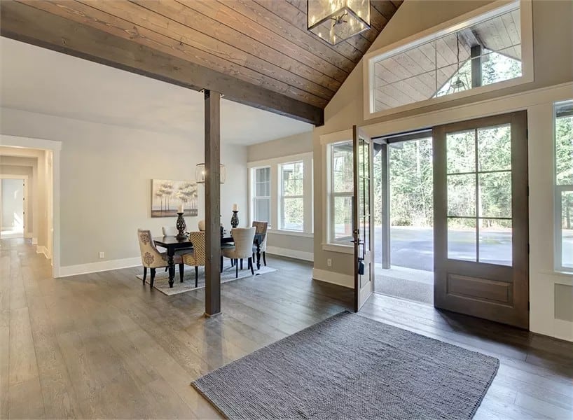 Foyer with a French entry door, a transom window, and a cathedral ceiling clad in wood planks.