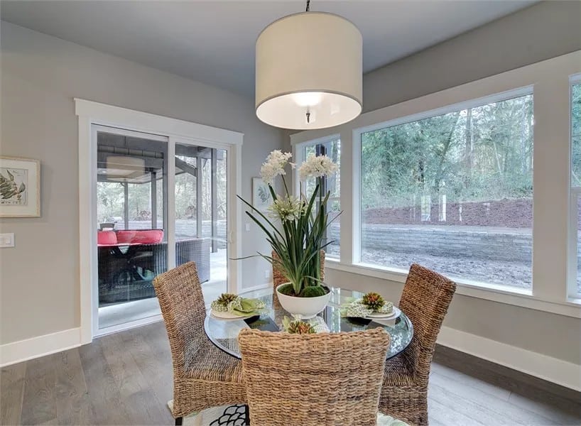 Breakfast nook with a round dining set and sliding doors that open to a covered patio.