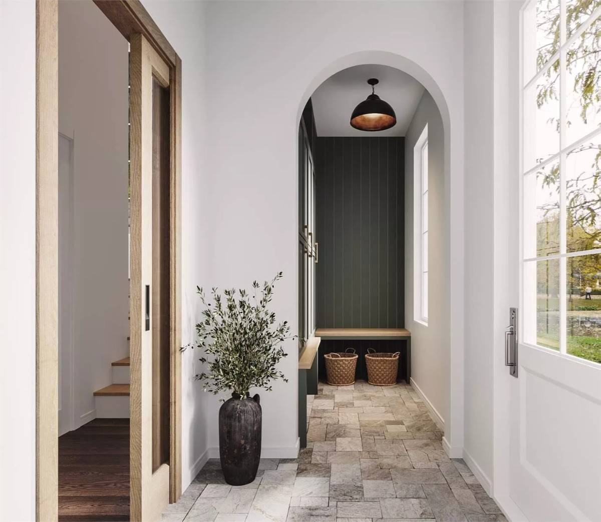 Foyer with a pocket door, an archway, built-in lockers, and a bench.