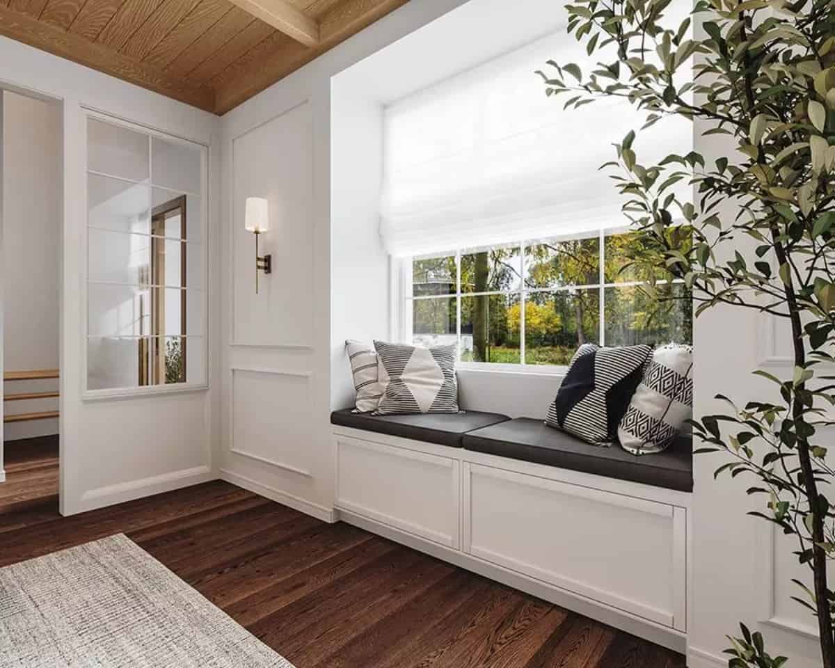 Window seat nook with leather cushions and patterned throw pillows.