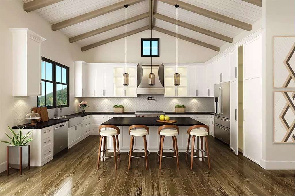 Kitchen with white cabinetry, contrasting countertops, and a center island with bar seating.