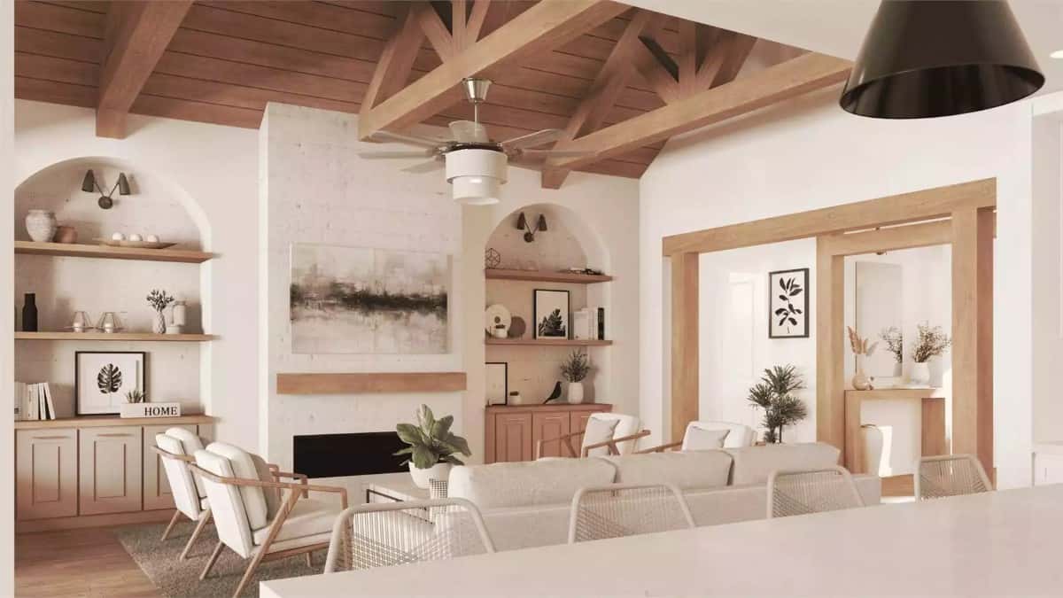 A cathedral ceiling framed with exposed trusses crowns the living room.