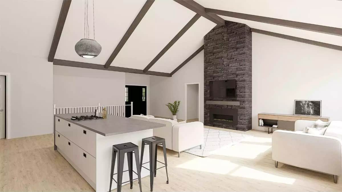 Great room with modern sofas and a stone fireplace under a vaulted ceiling with exposed beams.