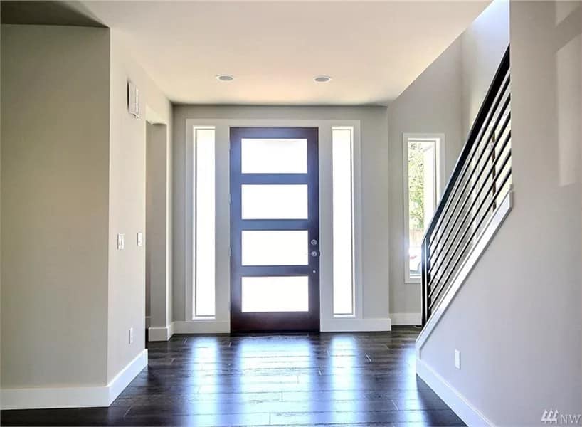 Foyer with a glazed front door and a staircase leading to the sleeping quarters.