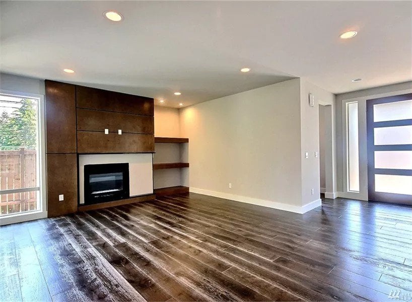 Great room with dark wood cabinets and a fireplace.