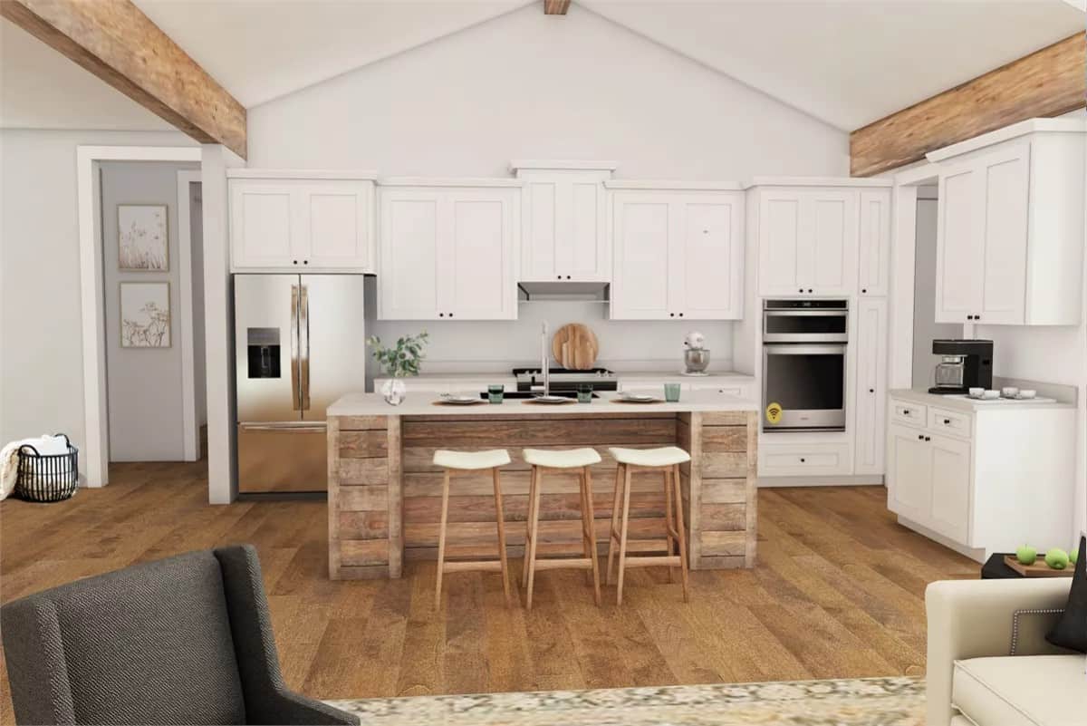 Kitchen with white cabinets, modern appliances, and a breakfast island with three seating.