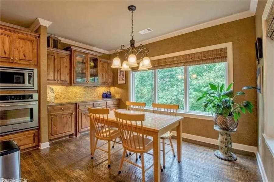 Breakfast nook with a wooden dining set and a built-in buffet cabinet.