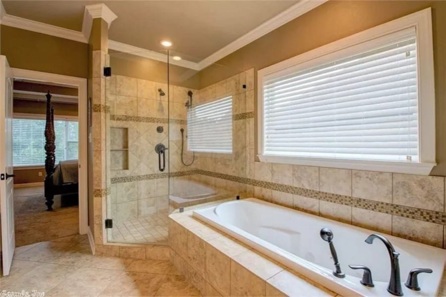 The primary bathroom includes a walk-in shower with a glass-hinged door.