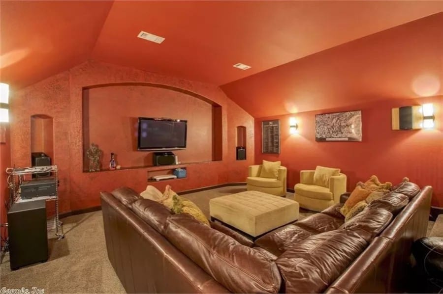 Media room with red walls and a matching vaulted ceiling.