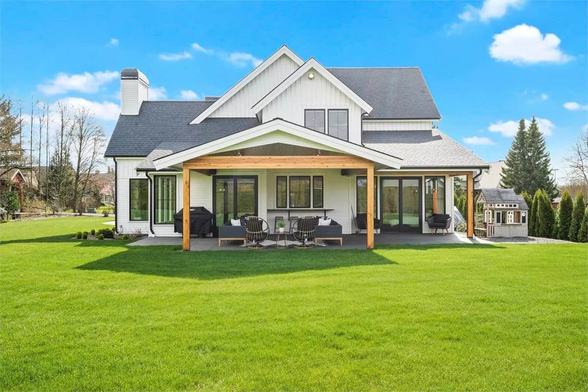 Rear view of the house showcasing a covered patio framed with timber posts.