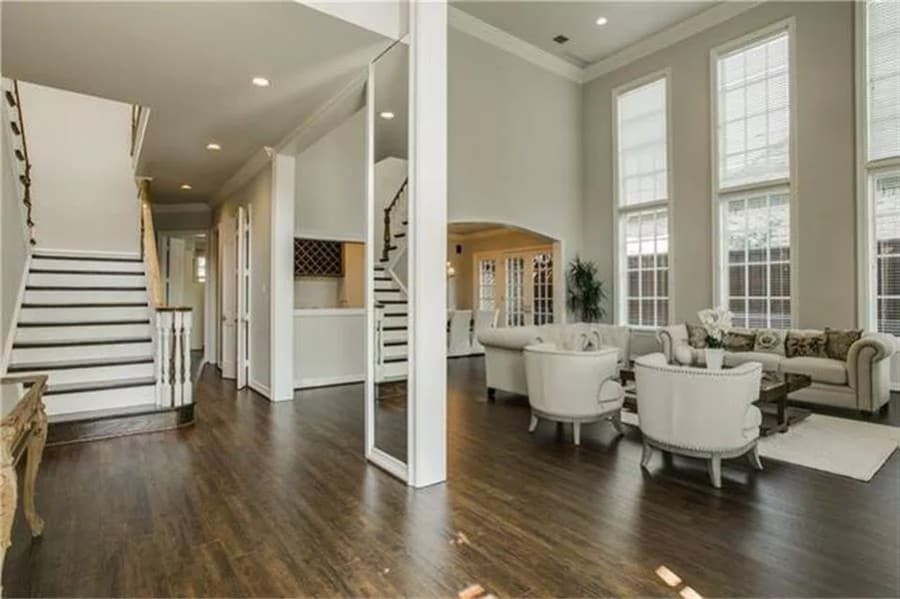 Foyer and family room separated by a mirrored pillar.