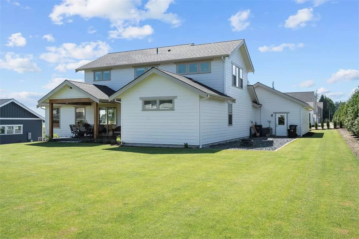 Rear-left view with clapboard siding and a covered patio.
