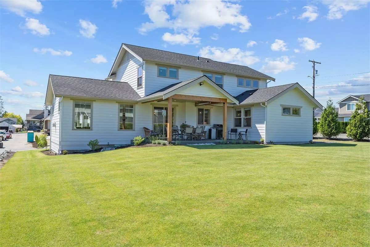 Rear-right view with plenty of windows and a covered patio.