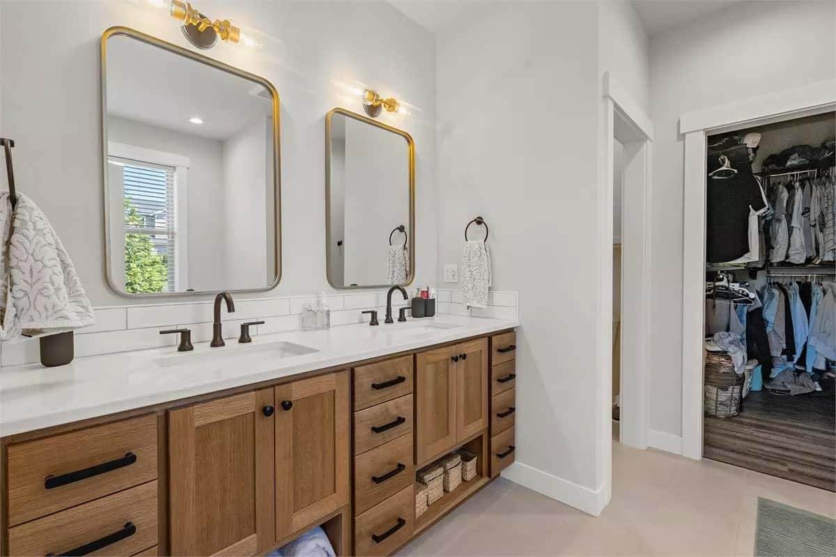 Primary bathroom with a dual sink vanity and a walk-in shower.