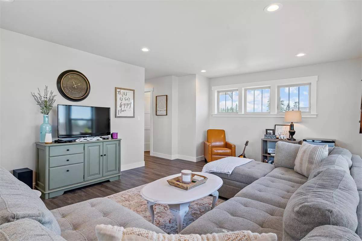 Playroom with a large tufted sectional and a TV sitting on the cabinet.
